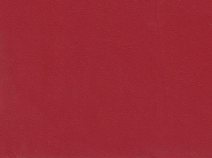 The image is a close-up of a red surface, possibly a fabric or a paper, with a uniform and smooth texture.
