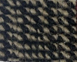 a close up of a rug on a white surface
