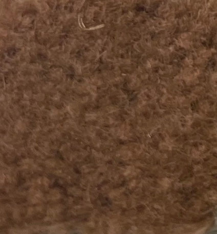 a close up of a pile of brown wool
